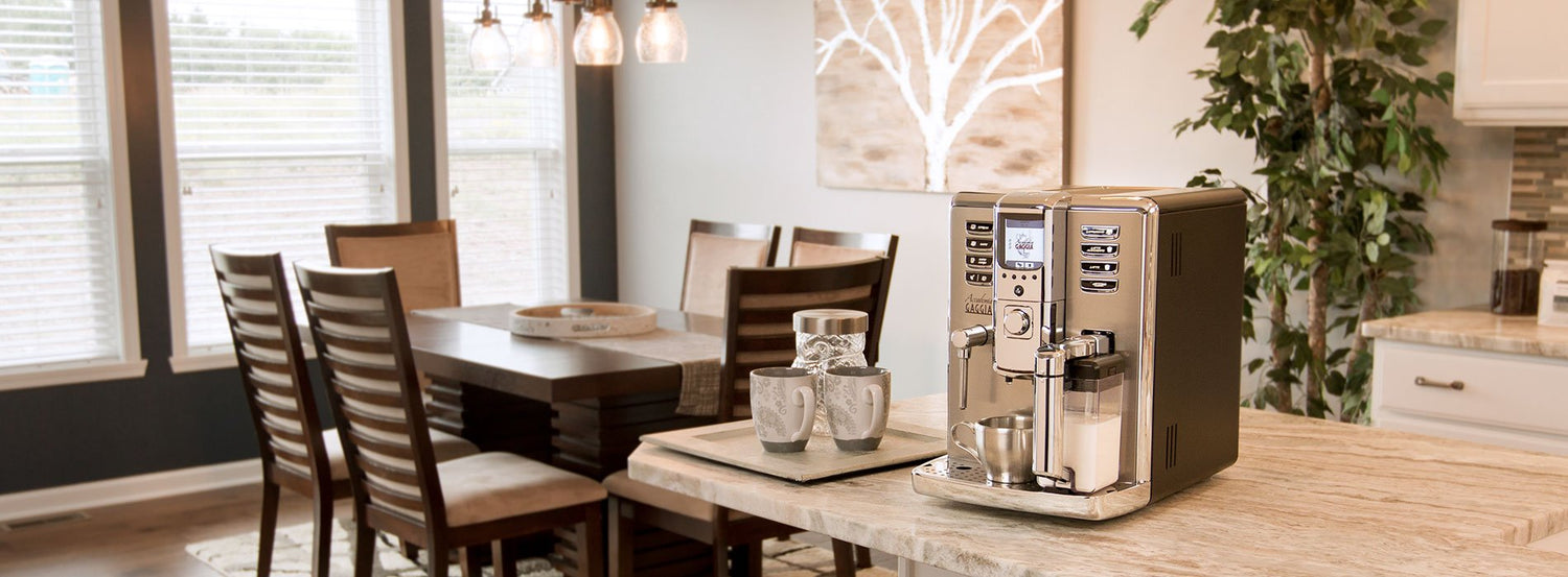 A Gaggia Accademia automatic espresso machine on a white wood kitchen counter.