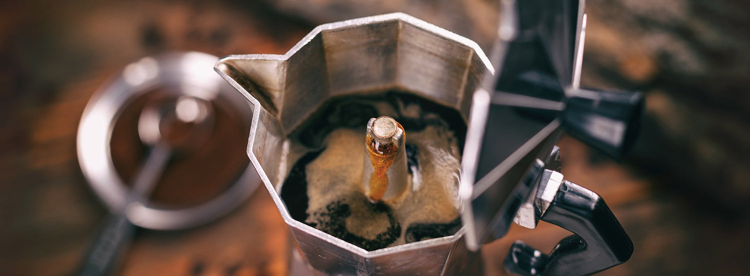 An open Bialetti Moka Pot filled with brewed coffee