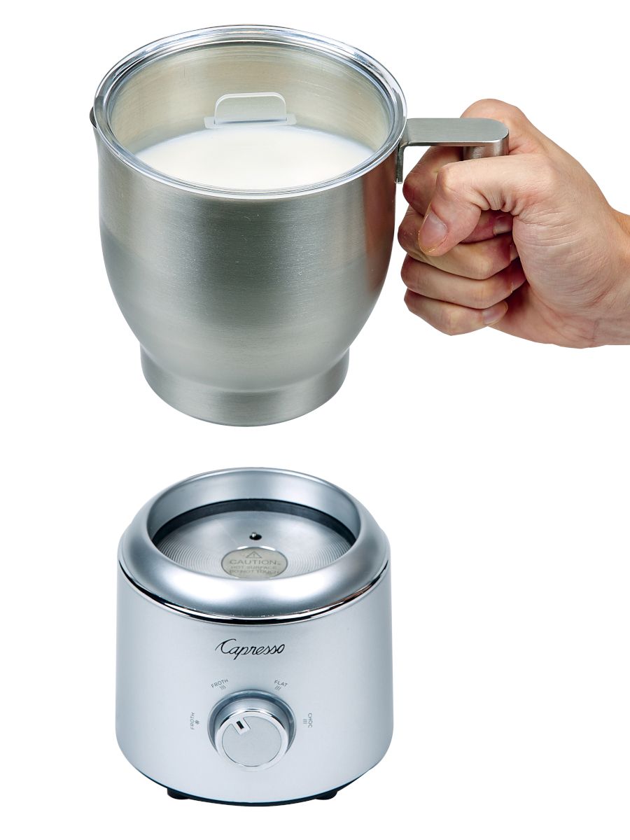 Frothing carafe being removed from the base.