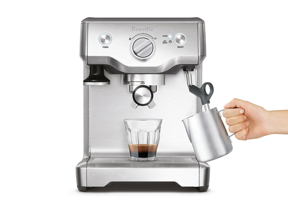 Breville BES810BSS Duo-Temp Pro Espresso Machine with glass cup and milk carafe.