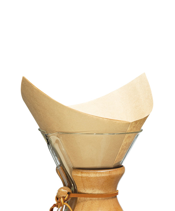 A Chemex pre-folded unbleached filter resting in a Chemex coffee maker
