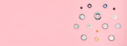 Grinder accessories laid out on a pink background. 