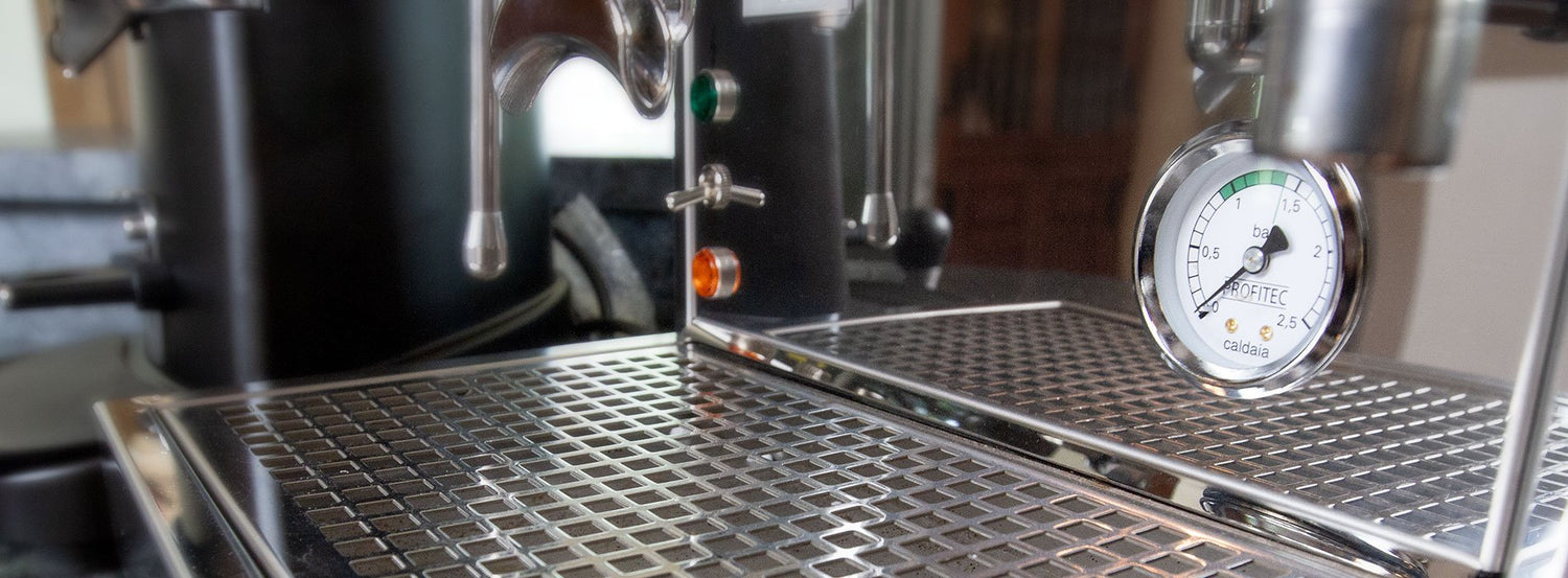 Close up shot of the drip tray and pressure gauge of one of Whole Latte Love's many single boiler espresso machines
