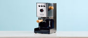 Close-up of the Gaggia Classic UP in Stainless Steel with Tiger Maple accents on a blue background. 