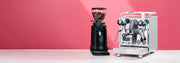 Profitec Pro 500 with PID next to a black Ceado E5Pro on a kitchen counter and in front of a pink background.