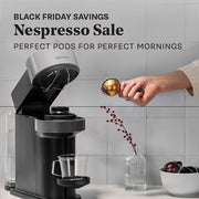 Nespresso coffee machine with a hand adding coffee pods to it, against a gray tiled wall. Promotional text that reads Nespresso Sale - Perfect pods for perfect mornings.