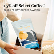 Person holding a bag of Whole Latte Love Crema Wave with promotional text for Black Friday savings on coffee.