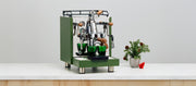 Green espresso machine on a white surface with a minimal background