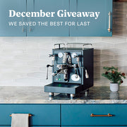 Espresso machine on a kitchen counter with blue cabinets and a December Giveaway text overlay.