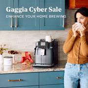Woman drinking coffee next to a Gaggia Cadorna coffee machine in a kitchen with 'Gaggia Cyber Sale' text.