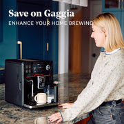 Woman using a Gaggia Accademia coffee machine in a kitchen with promotional text that reads "Save on Gaggia".