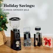 Eureka grinder sale with coffee grinders and on a wooden surface.