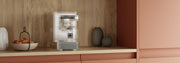 Pixelated mystery machine in a wooden coffee nook with salmon colored cabinets.