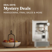 Pixelated mystery machine in a wooden coffee nook with salmon colored cabinets. Promotional text overlayed that reads "Deal Days: Mystery Deals - Markdowns, Final Sales & More".