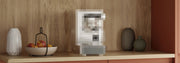Close-up of a pixelated mystery machine in a wooden coffee nook with salmon colored cabinets.
