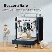 Bezzera espresso machine on a wooden surface with a light gray tiled wall in the background.