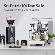ECM Mechanika Max next to an ECM S-Automatik 64 Grinder on a white counter with coffee accessories. Promotional text overlayed that reads "St. Patrick's Day Sale - Save up to $125 + FREE Gifts".