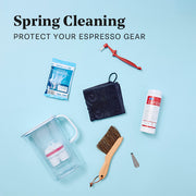 Close-up of spring cleaning tools, filters and supplies laid out on a blue background with overlayed text that reads "Spring Cleaning - Protect your espresso gear".