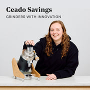 Woman next to a Ceado E37Z-Hero Coffee Grinder on a white counter  in front of a white wall with promotional text that reads "Ceado Savings - Grinders with innovation".