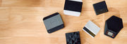 Looking down at various varia, brewista and acaia scales laid out on a wooden counter top.