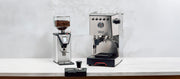 Close-up of the Gaggia Classic GT next to a Gaggia MDF 55 on a white counter in front of a gray wall.