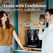 Close-up of a man and woman enjoying coffee together in a kitchen with a Gaggia Accademia espresso machine in the background. Promotional text overlayed that reads "Learn with Confidence - Guides, Experts, and Support".