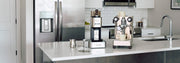 A Lelit coffee bundle on a white counter in a modern kitchen. 