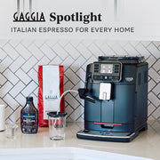 Gaggia Cadorna Milk in Black on a white kitchen counter next to a bag of coffee and chocolate sauce. Text overlayed that reads "Gaggia Spotlight - Italian Espresso for Every Home".