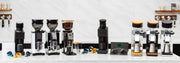 A lineup of professional coffee grinders  arranged on a white countertop against a light marble backsplash. The machines feature black, silver, and stainless steel finishes.