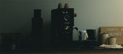 Close-up of the Gaggia Classic UP on a counter with cups and a sign reading 'Today's Brew Beaned Up' in a dimly lit room.