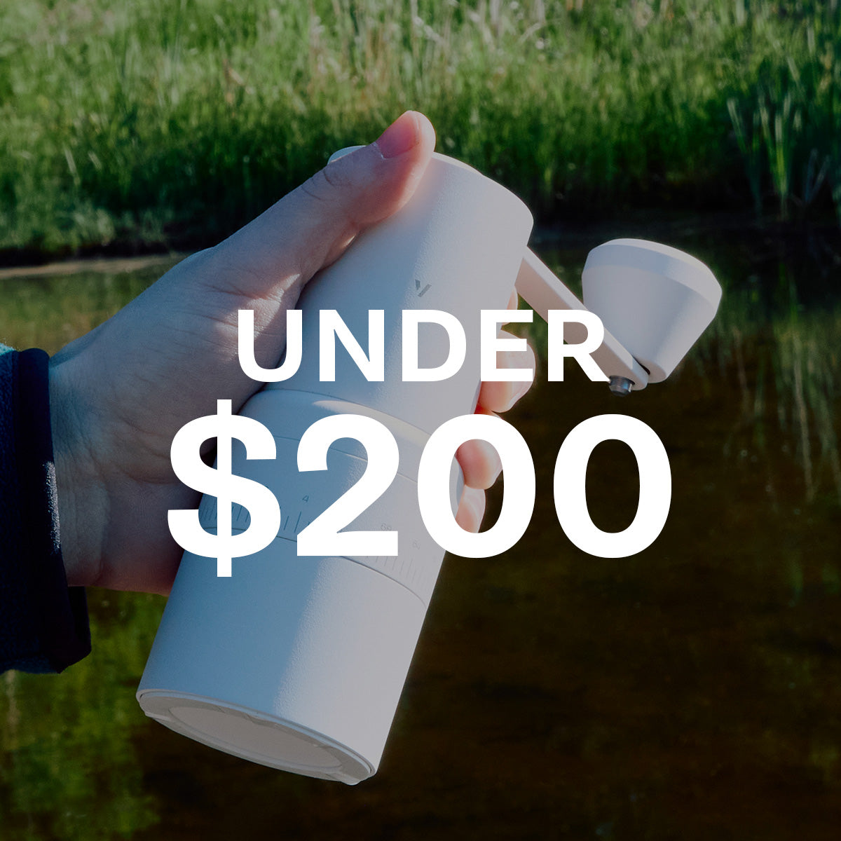 Person holding a Varia hand grinderin white outside. Text overlayed that reads "Under $200" which leads to a collection of products under $200.