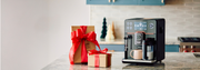 Gaggia Accademia Super-Automatic machine on a kitchen counter next to a holiday present.