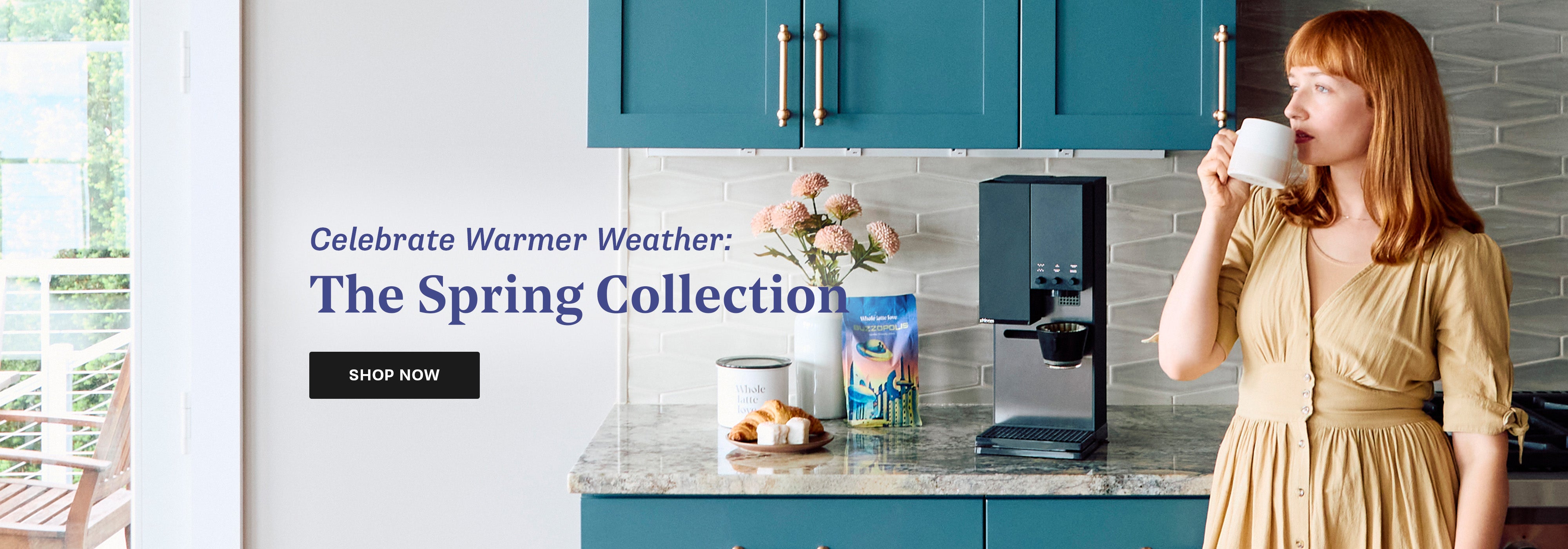 Woman in a kitchen in front of a xbloom coffee maker on a kitchen counter with text overlayed to Celebrate Warmer Weather with the Spring Collection.