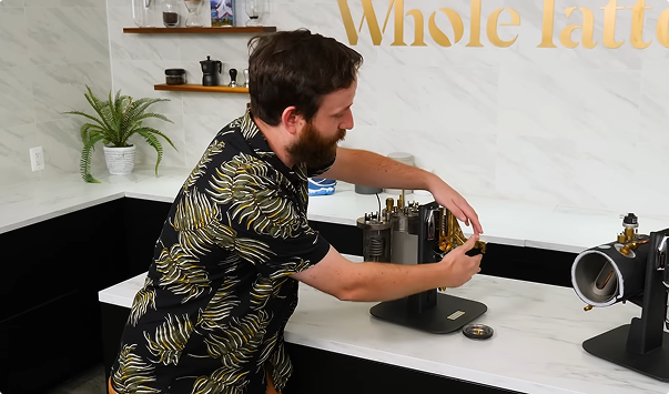 Man working with coffee equipment in a modern kitchen setting