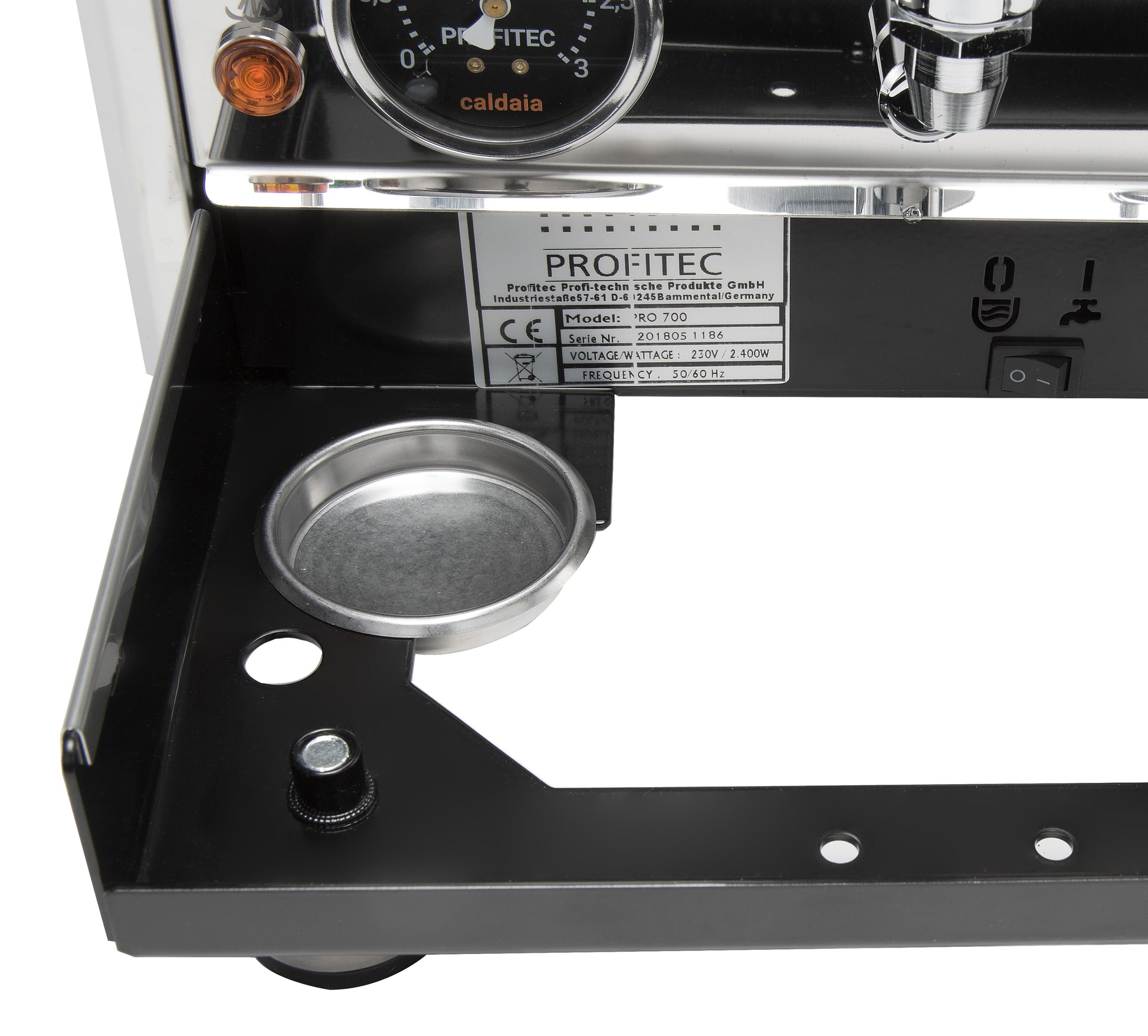 Frame compartment for backflush disc and steam tip and water supply switch.